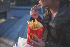 woman in brown classic trench coat eating mcdo fries during 139681 1